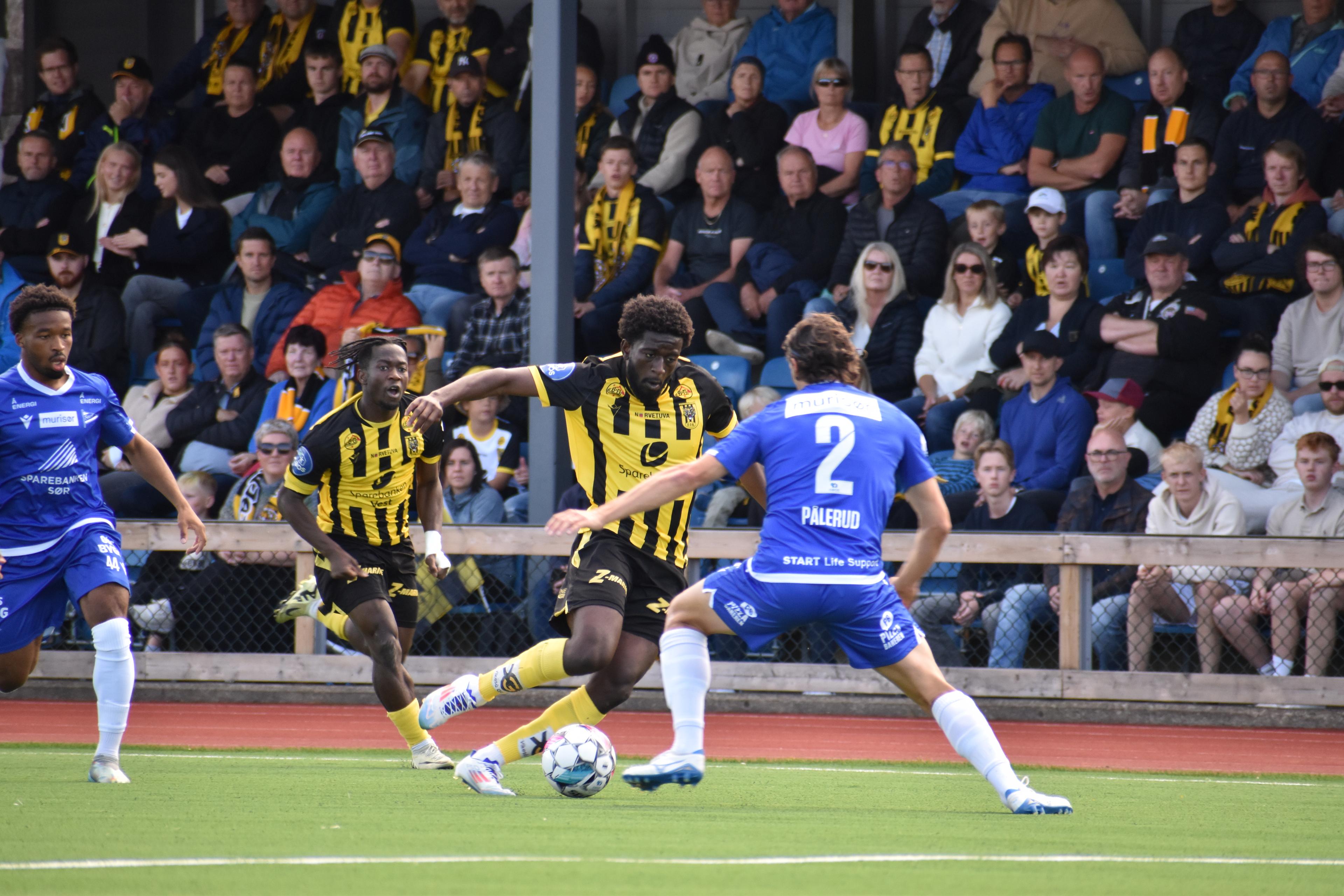 Fotballspillere spiller fotball på banen