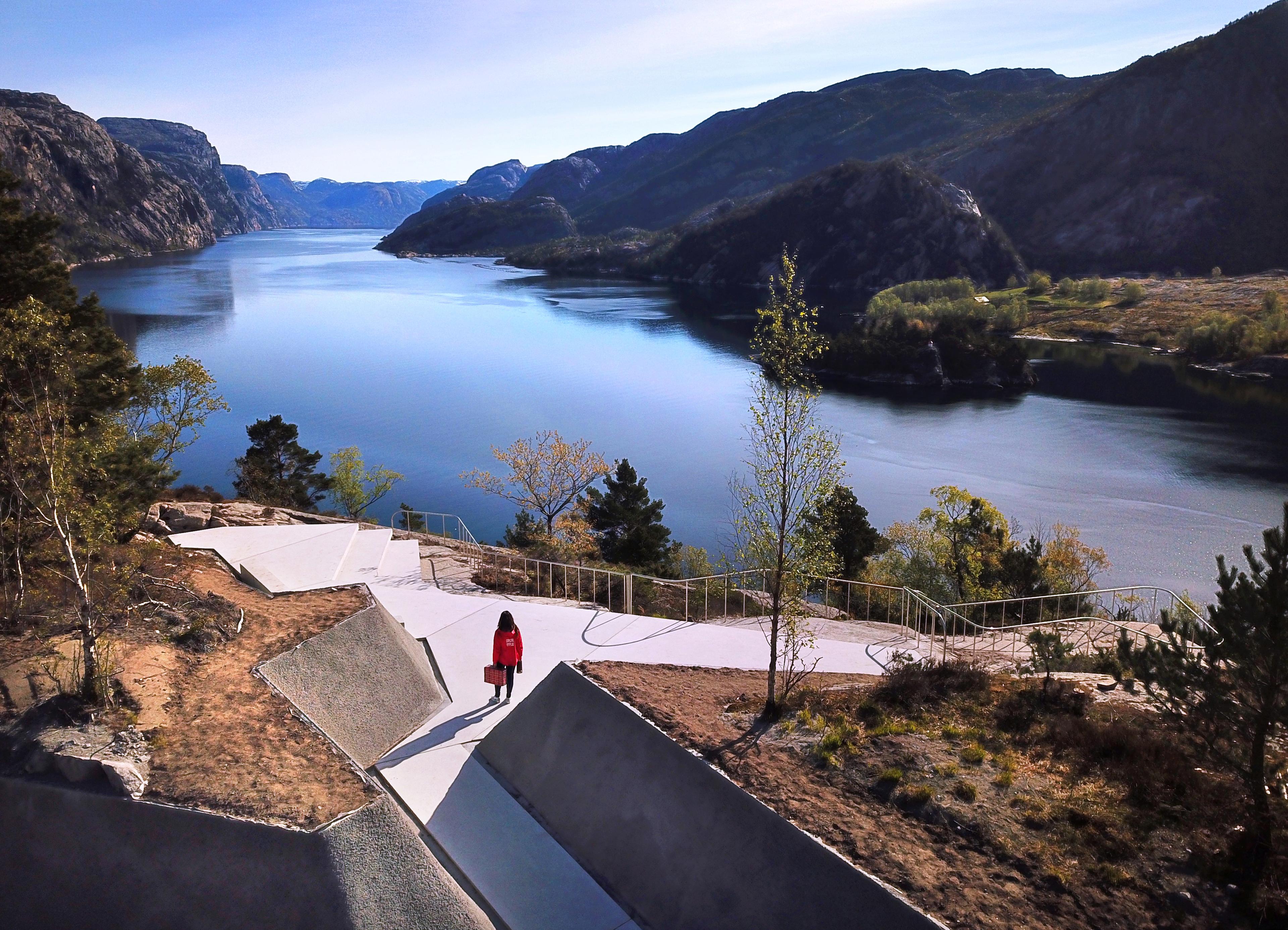 En dame som kikker utover Lysefjorden fra utsiktspunktet på Høllesli.