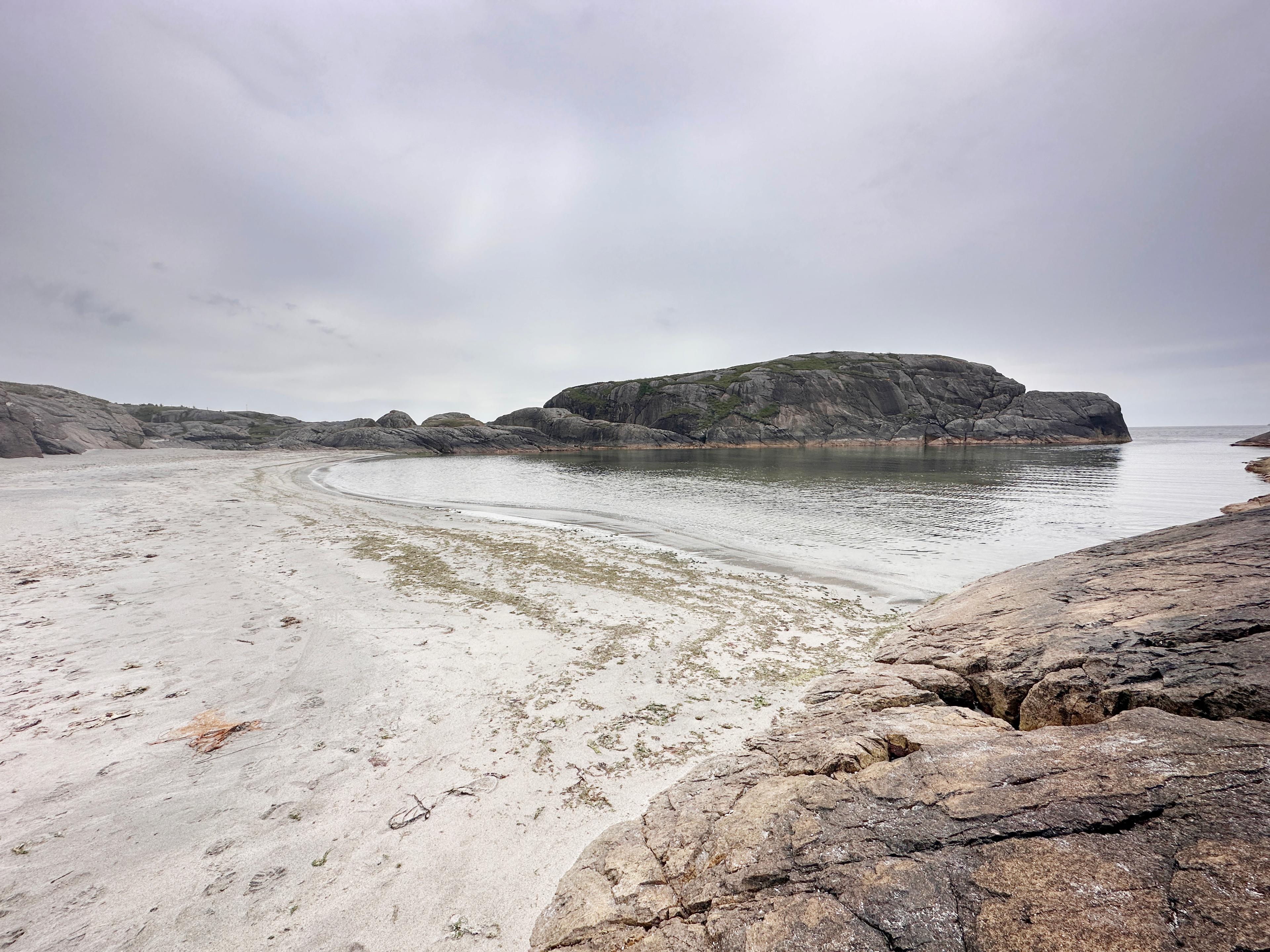 The Ogna beach (Ognasanden) with rocks and sandy beach as well as marsh grass. The sea in the backend of photo